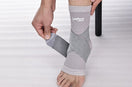 man wearing a gray ankle binder with leeford branding