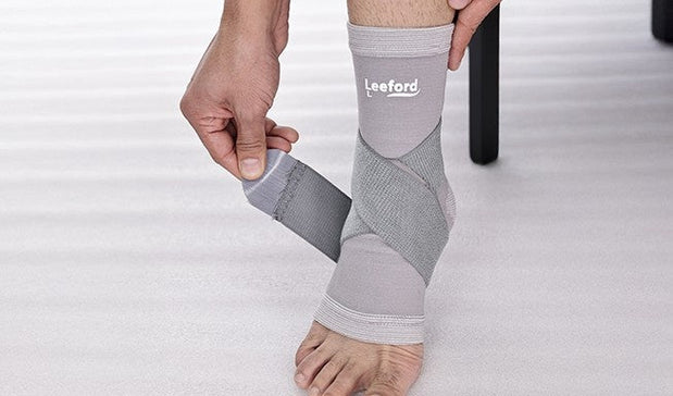 man wearing a gray ankle binder with leeford branding
