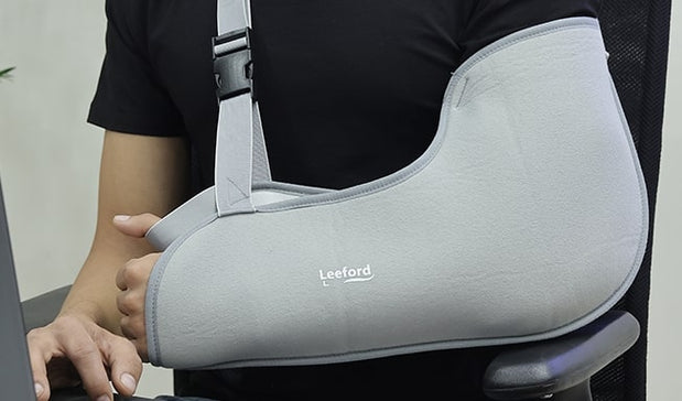 person wear arm sling in left arm with leeford branding