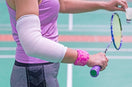 Badminton Player wear Elbow Support in service gaming mode