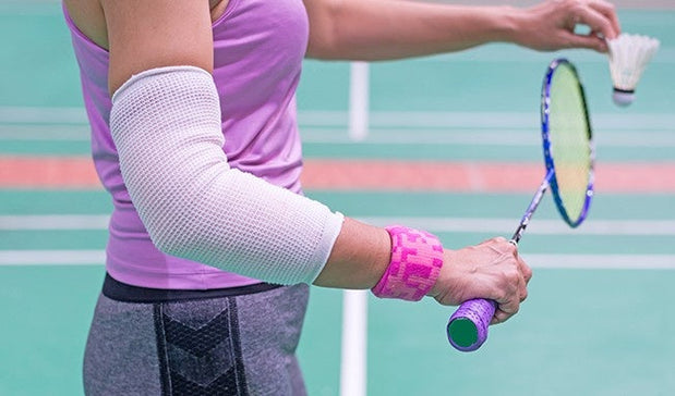 Badminton Player wear Elbow Support in service gaming mode