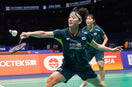man plays badminton and wear knee support