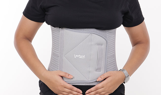 woman wear a gray belt after c section delivery 