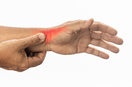 person indicating his wrist suffering from De Quervain’s Syndrome pain
