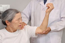 orthopedic specialist examine frozen shoulder of a women