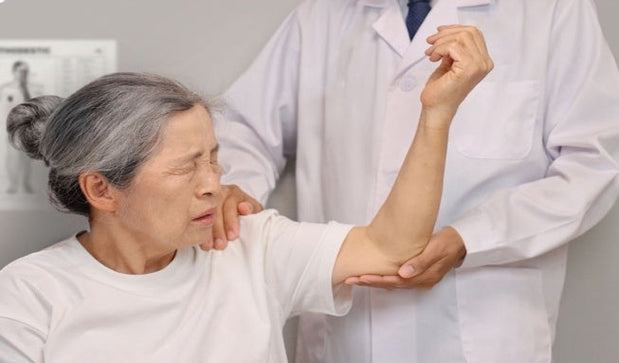 orthopedic specialist examine frozen shoulder of a women