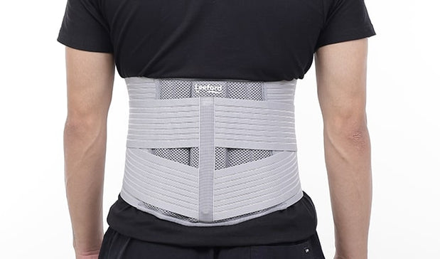 man wear gray lumbo sacral belt for pain relief