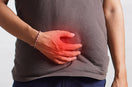 person hold his below abdomen area showing pain