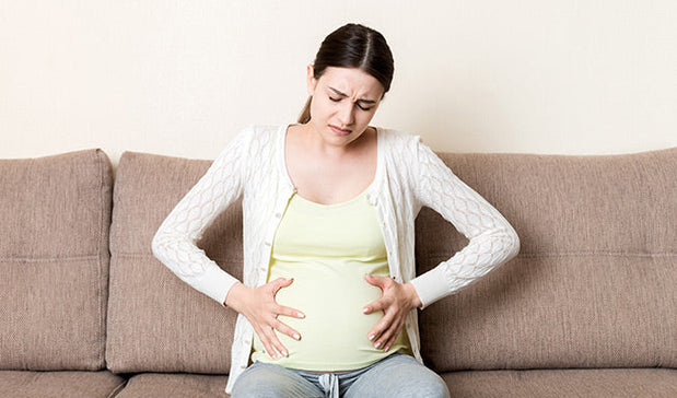 woman suffering from abdominal pain in pregnancy
