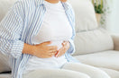 woman indicating abdominal pain