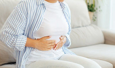 woman indicating abdominal pain