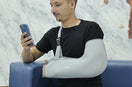 man using gray arm support