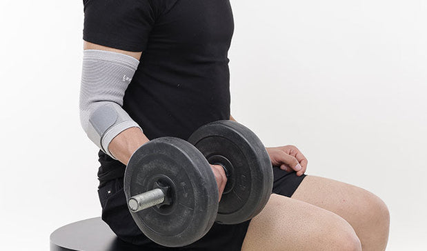 Person wear Elbow Brace during Gym Workouts