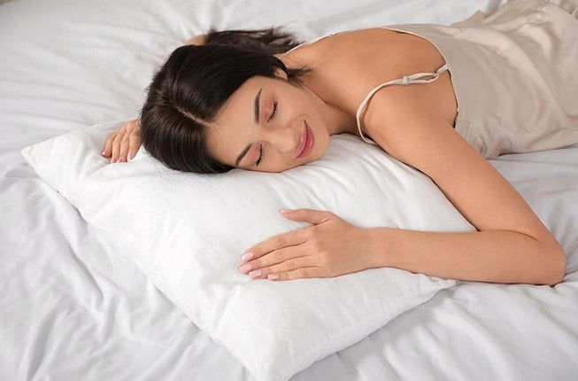 woman sleeping on a bed and pillow