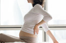 woman suffering from postpartum back & pelvic pain