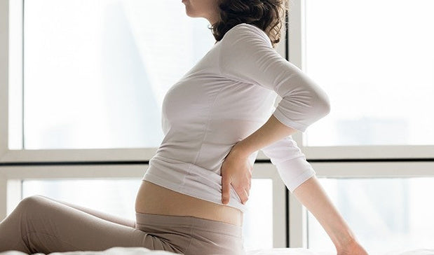 woman suffering from postpartum back & pelvic pain