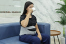 woman drinking tea and wear maternity support belt