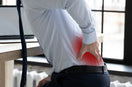 man suffering from Sciatica pain while working