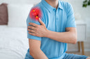 person indicating his left shoulder in pain