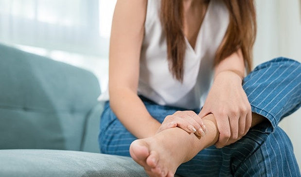 woman hold her left swollen ankle