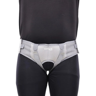 person wear a gray hernia belt
