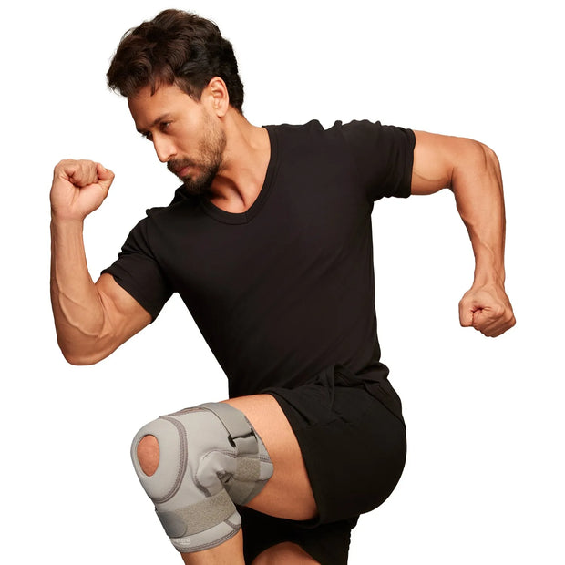 Man wearing a black t-shirt and shorts with a hinged knee cap