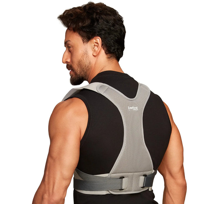 Man wearing a black and gray posture corrector belt