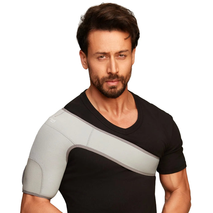 Man wearing a black shirt with a gray shoulder support belt