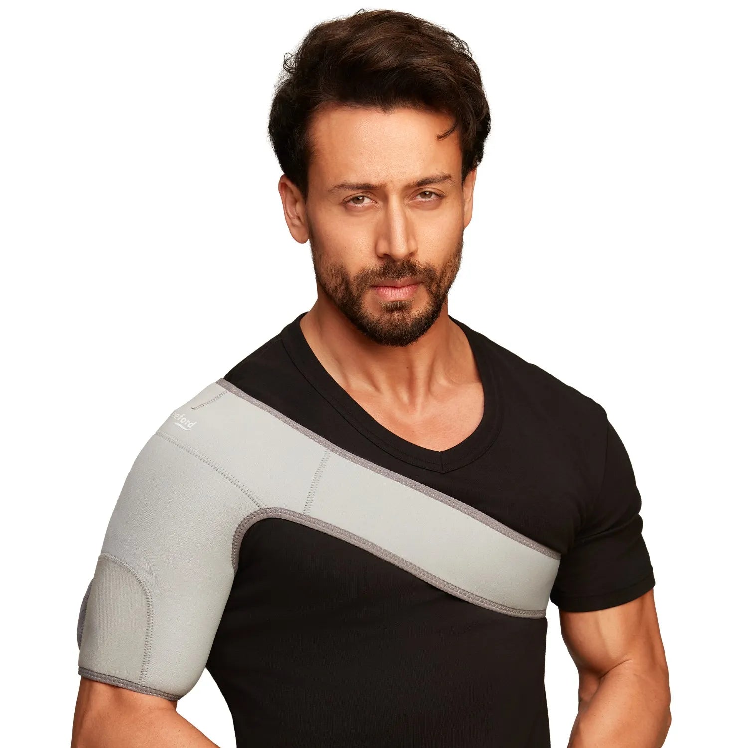 Man wearing a black shirt with a gray shoulder support belt