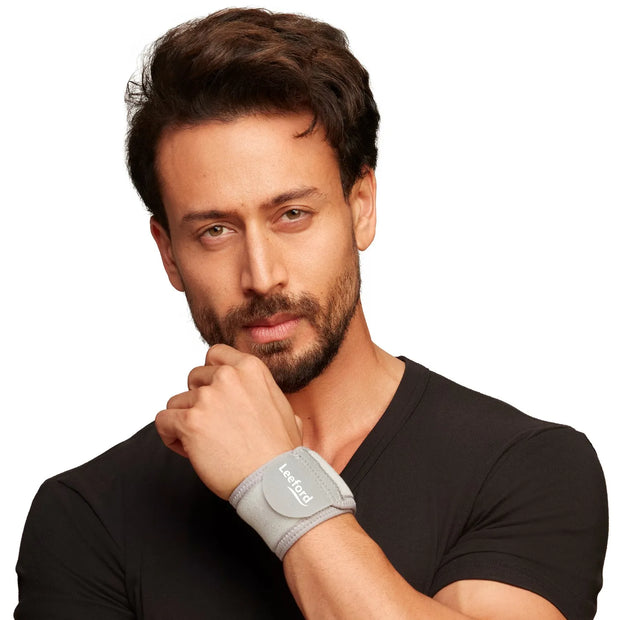 Man wearing a black shirt with a gray wrist wrap